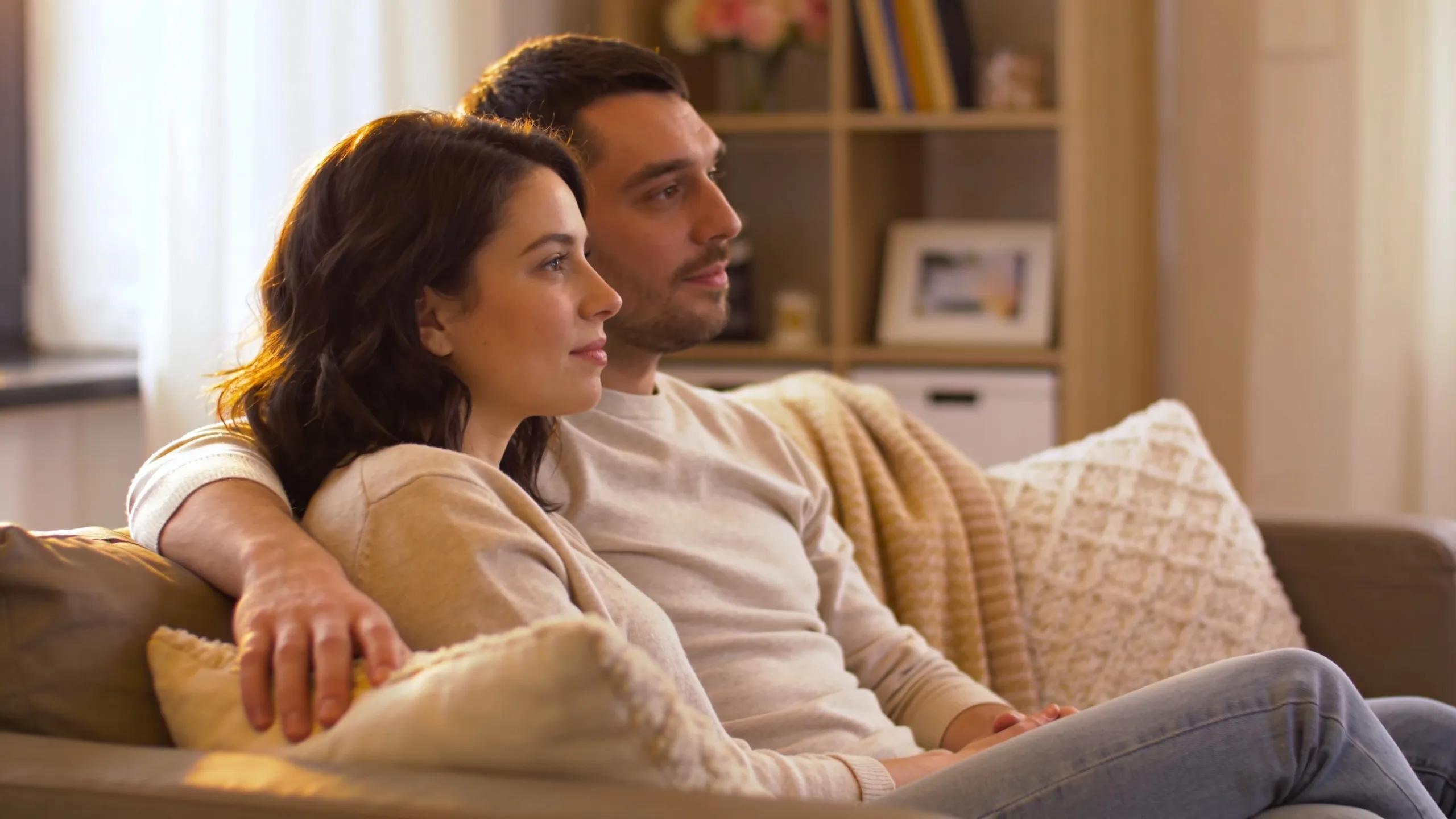 Couple discussing relationship concerns in a cozy setting, highlighting intimacy and trust.